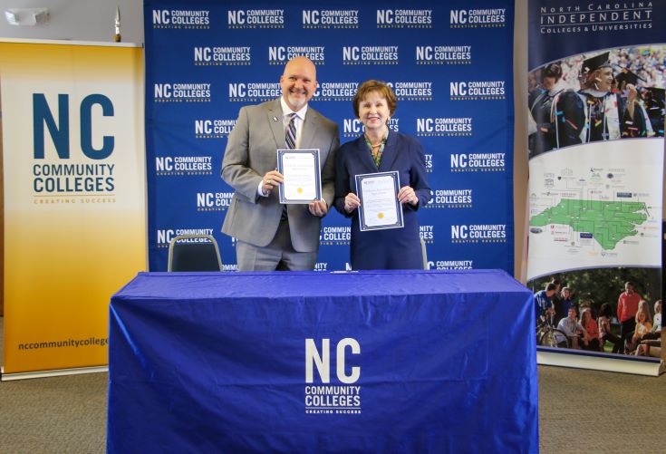 two people holding certificates